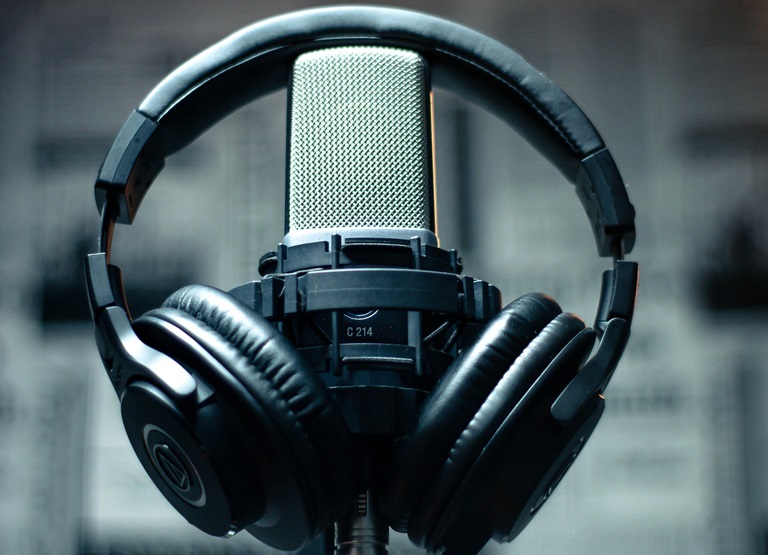 why podcasters wear headphones