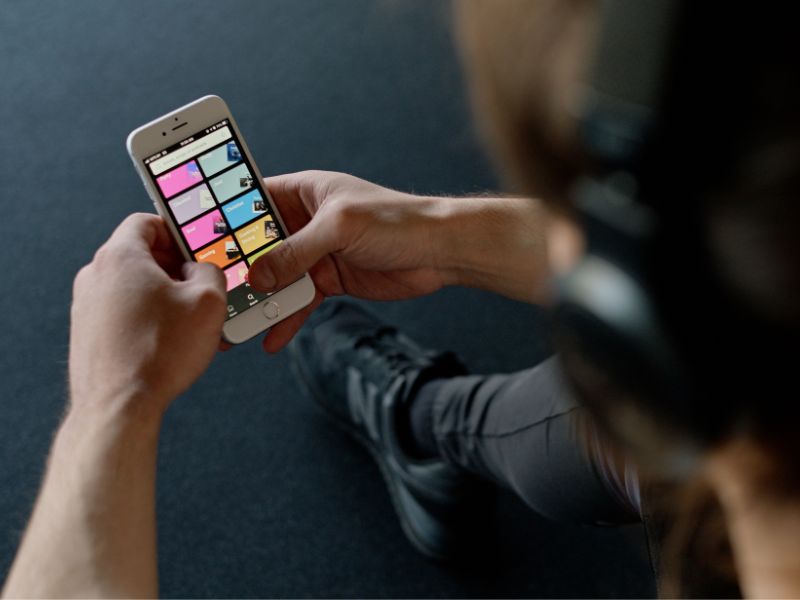 man playing spotify on iphone